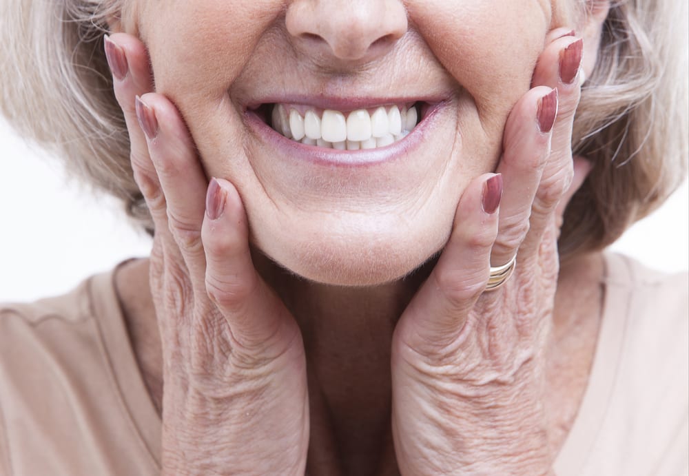 older woman holding her cheeks